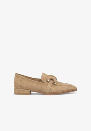 Beige suede loafers with a rounded toe, low block heel, and a decorative strap detailed with metallic accents. Smooth texture throughout.