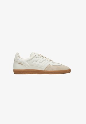 White sneakers with beige suede accents, rubber sole, and prominent logo. Features textured panels and flat laces. Reinforced toe design.