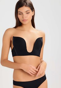 Black plunge bra featuring smooth fabric, contour cups, and seamless edges for a discreet look. Adjustable straps enhance fit.
