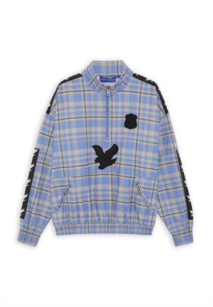 Veste à enfiler à carreaux bleu clair et beige avec demi-fermeture éclair, écusson d'aigle noir sur la poitrine, détails noirs avec imprimés d'aigle blanc sur les manches, ourlet élastique.