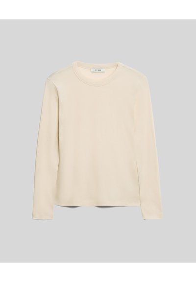 Pikkade varrukatega kreemivärvi T-särk, mis on valmistatud pehmest kangast, ümarate kaeluste ja sirge äärisega. Minimalistlik disain.