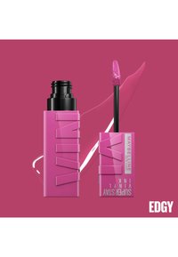 Rouge à lèvres liquide rose dans un tube rectangulaire avec un design texturé. Comprend un applicateur noir ; a une finition brillante et une teinte vibrante.