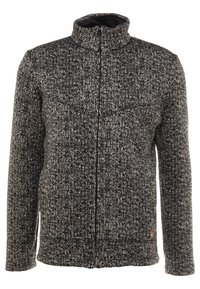 Giacca zippata in maglia nera e grigia con un motivo testurizzato, colletto alto e un sottile accento arancione vicino all'orlo.