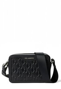 Čierna kabelka na rameno z textúrovanej kože s geometrickým vzorom, so zipsovým uzáverom a nastaviteľným popruhom. Logo na prednej strane.