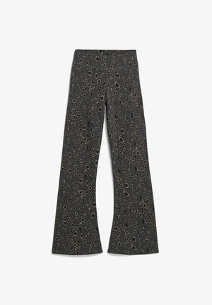 Black flared leggings featuring a leopard print pattern in shades of gold and brown, with a smooth, stretchy fabric and an elastic waistband.
