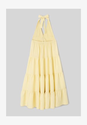 Robe jaune à col halter avec corsage smocké et jupe fluide à volants, nouée en nœud au cou.
