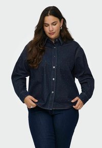 Dark denim shirt featuring a button-up design, long sleeves, light stitching, and scattered bead accents for texture.