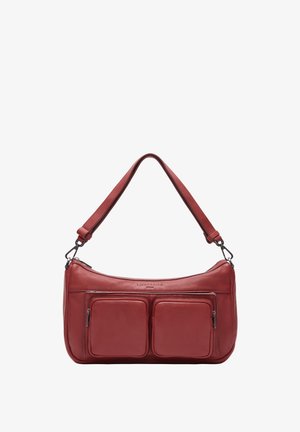 Red leather shoulder bag with two front zip pockets, curved shape, and a flat strap. Smooth texture, with subtle embossed branding on the front.