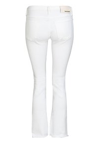 White flared jeans made of cotton with a smooth texture. Features back pockets and a leather patch at the waist. Raw hem at the ankles.