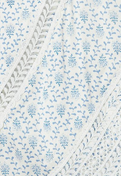 Tessuto bianco con piccoli motivi floreali e di vite blu, con sezioni di rifinitura in pizzo bianco con disegni smerlati e floreali.