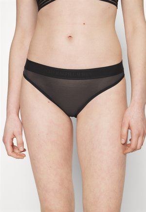 Black sheer underwear with a wide black waistband featuring embossed logo. Smooth texture and classic cut design for a minimalist appearance.