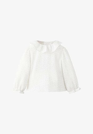 White long-sleeve blouse with a ruffled collar, textured fabric, and gathered cuffs. Subtle floral pattern throughout.