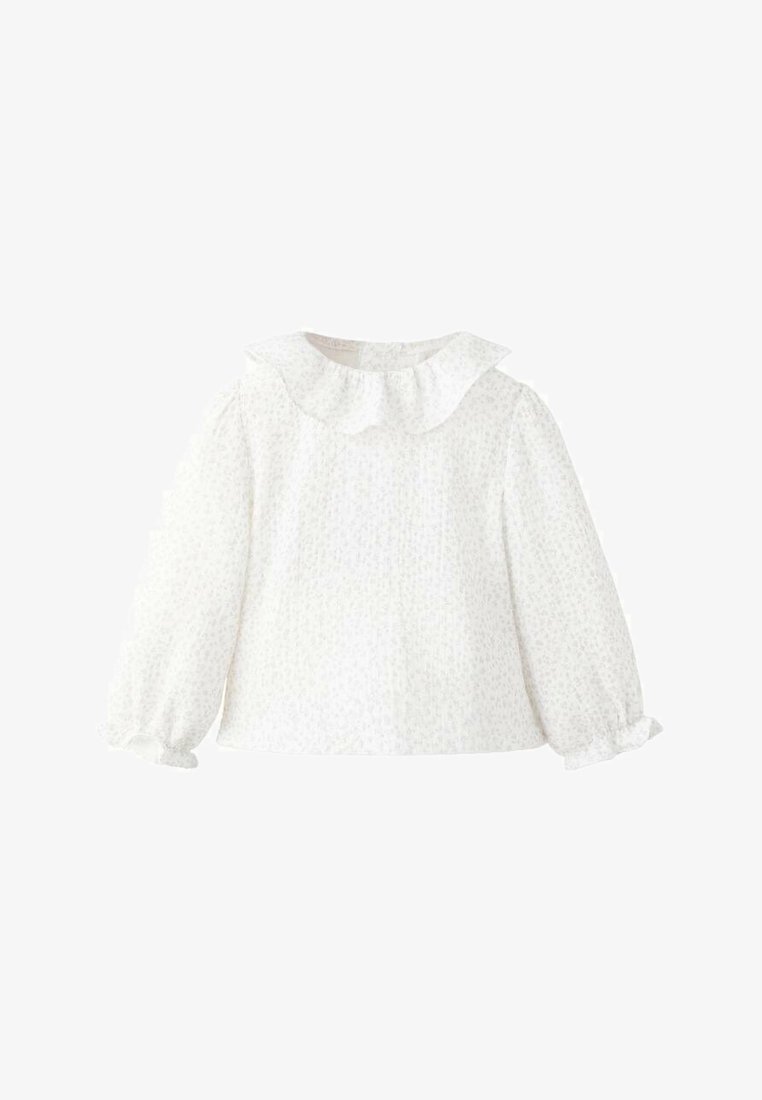Blusa bianca a maniche lunghe con colletto arricciato, tessuto strutturato e polsini gatherati. Motivo floreale sottile su tutta la superficie.