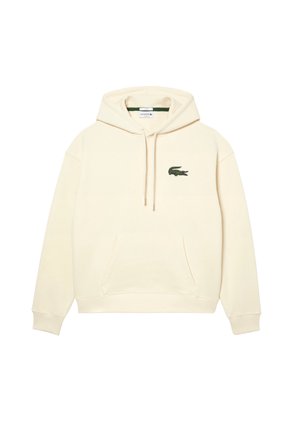 Sweat à capuche couleur crème avec poche kangourou à l'avant et petit logo crocodile vert sur la poitrine gauche.