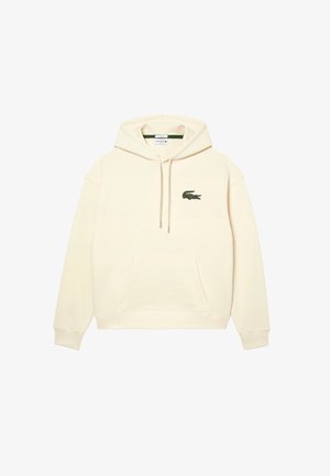 Sweat à capuche couleur crème avec poche kangourou à l'avant et petit logo crocodile vert sur la poitrine gauche.