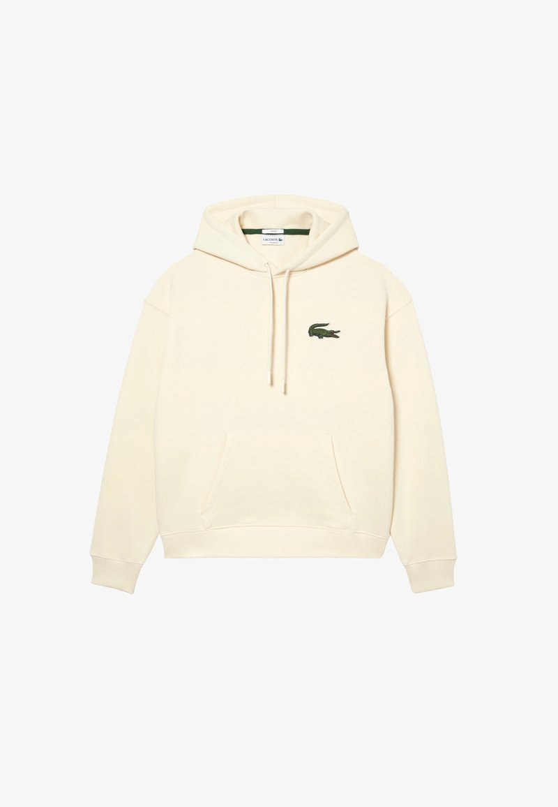 Sweat à capuche couleur crème avec poche kangourou à l'avant et petit logo crocodile vert sur la poitrine gauche.