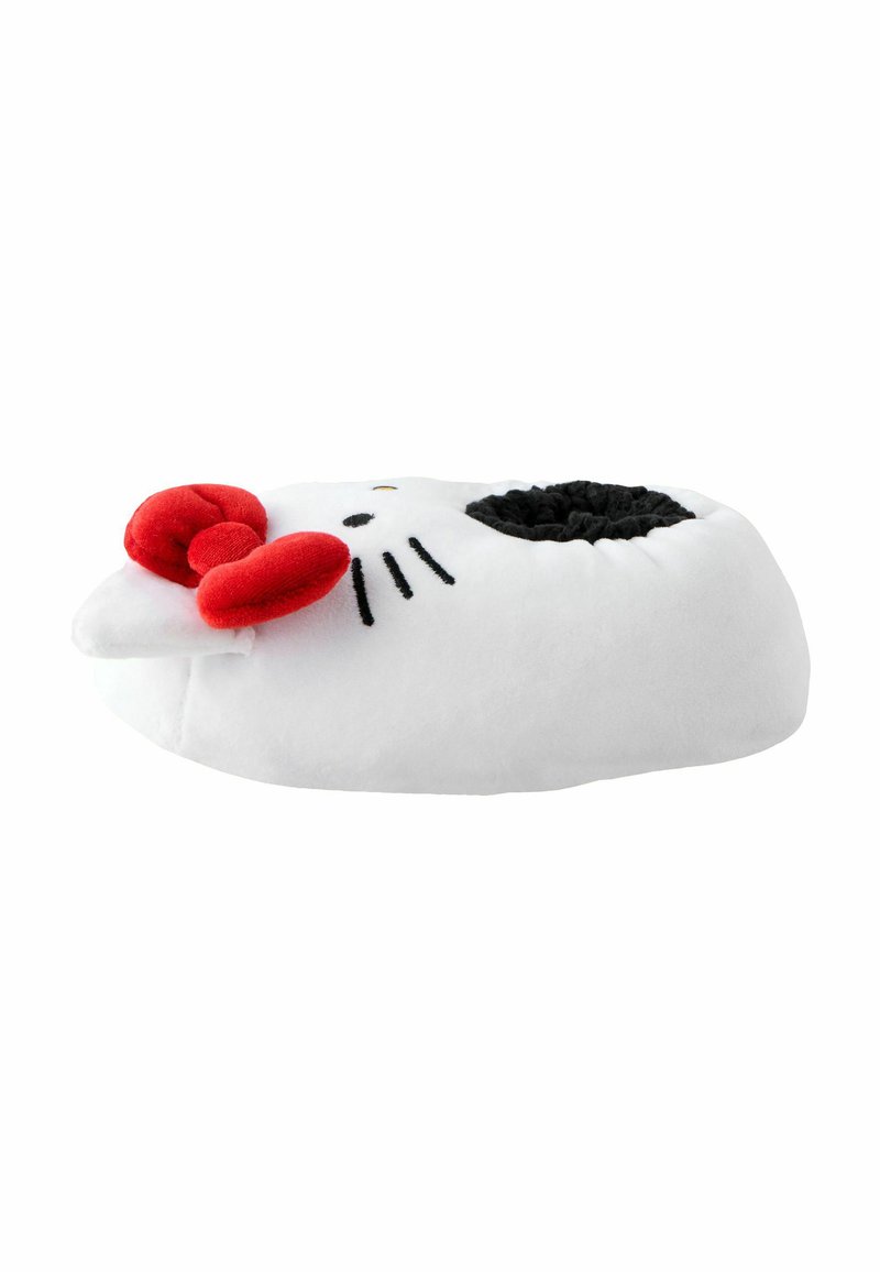 Hello Kitty-teemaline pehme suss, valge mustade aksentidega, millel on punane lips, must nina ja vuntsid; pehme tekstuur, ümar kuju.