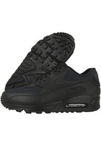 Svarta Nike Air Max-sneakers med en slät läder- och textilöverdel, gummisula, synlig Air-enhet och texturerade detaljer på sidorna.