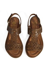 Braune, durchbrochene Leder-Sandalen mit flacher Sohle, ausgestattet mit einem Slingback-Riemen und runden Ausschnittmustern, die das Obermaterial akzentuieren.