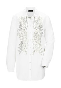 Camicia bianca con bottoni realizzata in tessuto dalla consistenza liscia. Presenta decorazioni in argento con un motivo astratto sul davanti. Maniche lunghe.
