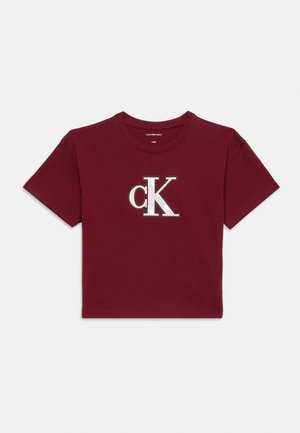 Burgundy short-sleeve crop top with white "cK" logo centered on the front and round neckline.