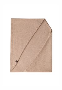 Pătură din lână de culoare bej deschis, de formă rectangulară, cu o textură netedă. Prezintă o margine subtilă ribatată și un mic etichetă de marcă în colț.