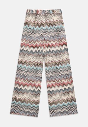 Wide-leg trousers featuring a zigzag pattern in various colors including cream, blue, red, and gray. Made from a textured fabric.