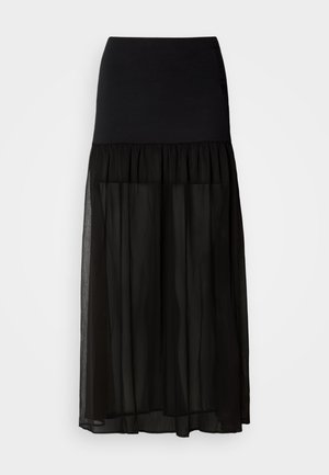 Fekete maxi szoknya, illeszkedő elasztikus derékpánttal, réteges, átlátszó chiffon alsó résszel a légies megjelenés érdekében.
