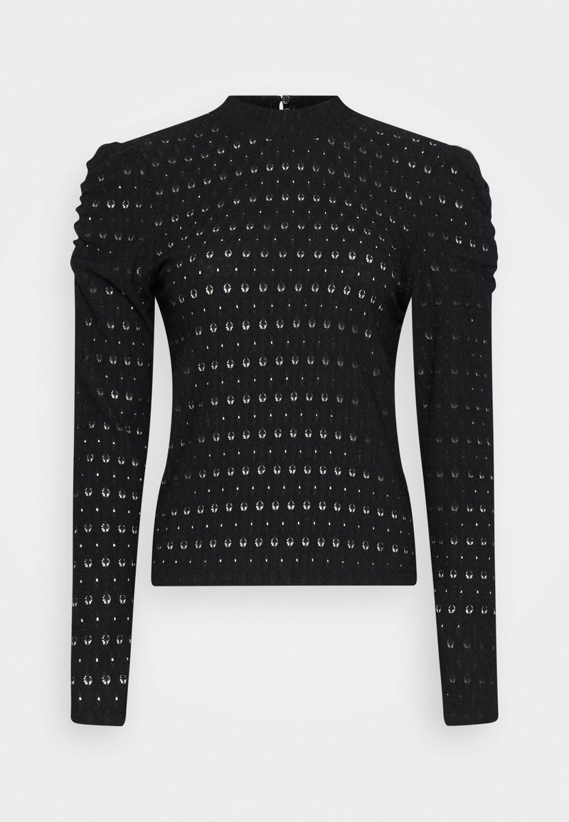 Svart långärmad topp med texturerad design som har cirkulära mönster, samlade axlar och en figurnära silhuett. Dragkedja i ryggen.