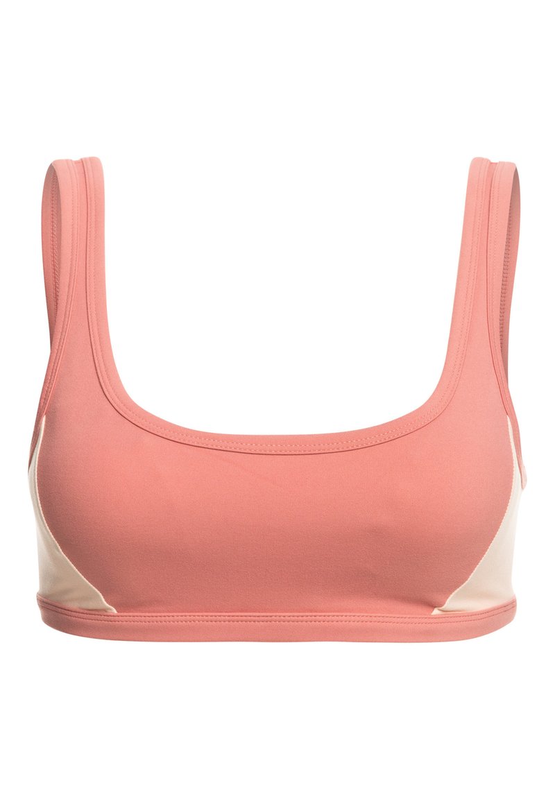 Sostenedor deportivo rosa y crema con escote cuadrado, tirantes anchos, tejido suave y paneles laterales en contraste.