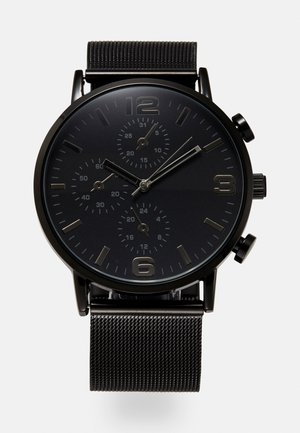 Black chronograph watch with a metal mesh strap. Features a black dial, silver hour markers, and three sub-dials for time tracking.