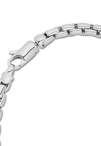 Silver metal bracelet featuring interlocking flat links and a sleek clasp closure, with a polished finish and smooth texture.