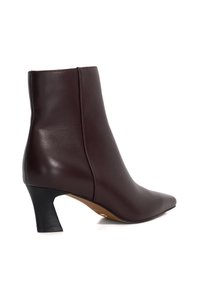 Maroon leather ankle boot with a pointed toe, mid-height block heel, and smooth texture. Sleek design with minimal hardware.