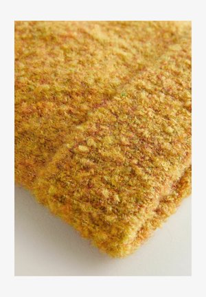 Wool knitted fabric in yellow and orange tones, textured with a fuzzy, looped surface, featuring visible, varied strands of yarn.