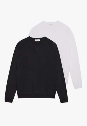 Black and white sweatshirts with round necks, made of soft fabric. Black features dark waistband and cuffs; white has light cuffs.