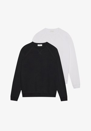 Black and white sweatshirts with round necks, made of soft fabric. Black features dark waistband and cuffs; white has light cuffs.