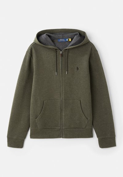 Grön zip-up hoodie med känguruficka, dragsko på huvan och grå foder. Har en liten logotyp på bröstet. Mjuk, strukturerad tyg.
