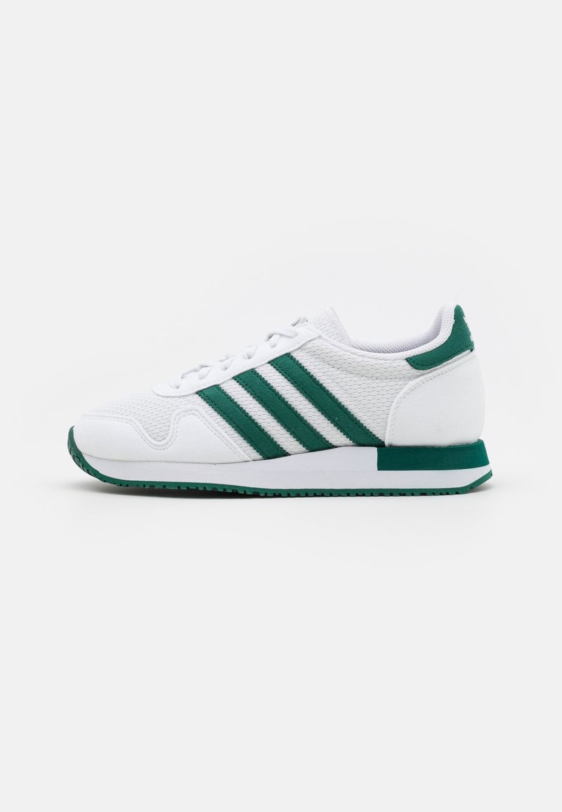 White athletic shoe with green stripes, mesh upper, rounded toe, cushioned sole, and contrasting green accents on the heel and midsole.