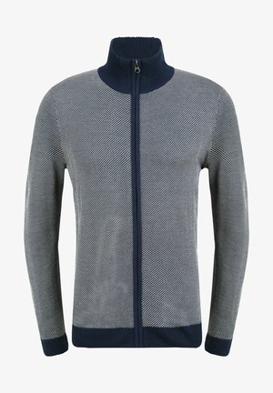 Marineblauwe en witte ritstrui met hoge kraag, voorzien van een gestructureerd visgraatpatroon en geribbelde boorden en onderrand.