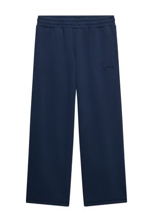 Pantalon de survêtement bleu marine à jambes larges avec ceinture élastique et logo discret brodé sur la partie supérieure de la cuisse gauche.