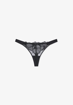 Black lace thong featuring floral patterned mesh on the front with a soft, solid black waistband and thin side straps.