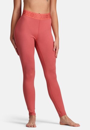 Koraalvormige leggings met een comfortabele, gestructureerde tailleband. Geschikt ontwerp en een gladde stof. Kenmerkt zich door een naaddetail langs de buitenbenen.