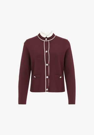 Burgundy cardigan made of wool with a round collar, white trim, and silver buttons. Features two front pockets.