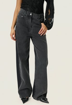 High-waisted, wide-leg black denim jeans with light wash detailing, front pockets, and two metal button closures at the waist.