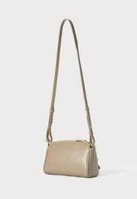Beige leather shoulder bag with a smooth texture, adjustable strap, zipper closure, and subtle gold hardware accents. Compact rectangular shape.