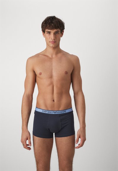 Tmavomodré bavlnené boxerky s svetlomodrým pásom s logom "Emporio Armani". Úzky strih s hladkou textúrou.