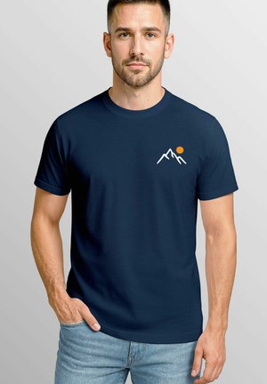 Navy blue cotton t-shirt featuring a white mountain graphic and an orange sun accent on the chest. Crew neck, short sleeves, and relaxed fit.