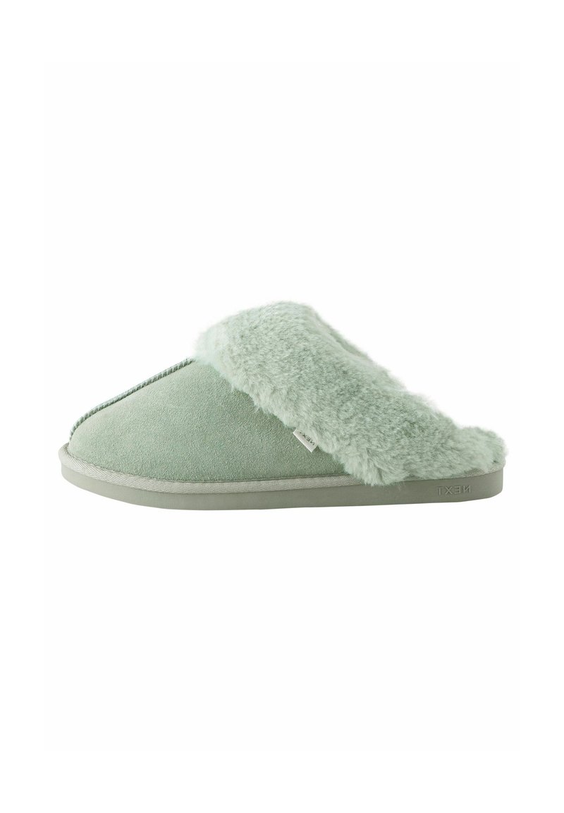 Green suede slipper with a fluffy, faux fur collar. Features a rounded toe, flat sole, and a simple stitched accent detail.