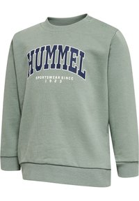 Grön sweatshirt med ribbat rundhals och muddar. Har en logotyp "HUMMEL SPORTSWEAR SINCE 1923" i marinblått över framsidan. Sidoknappar ingår.