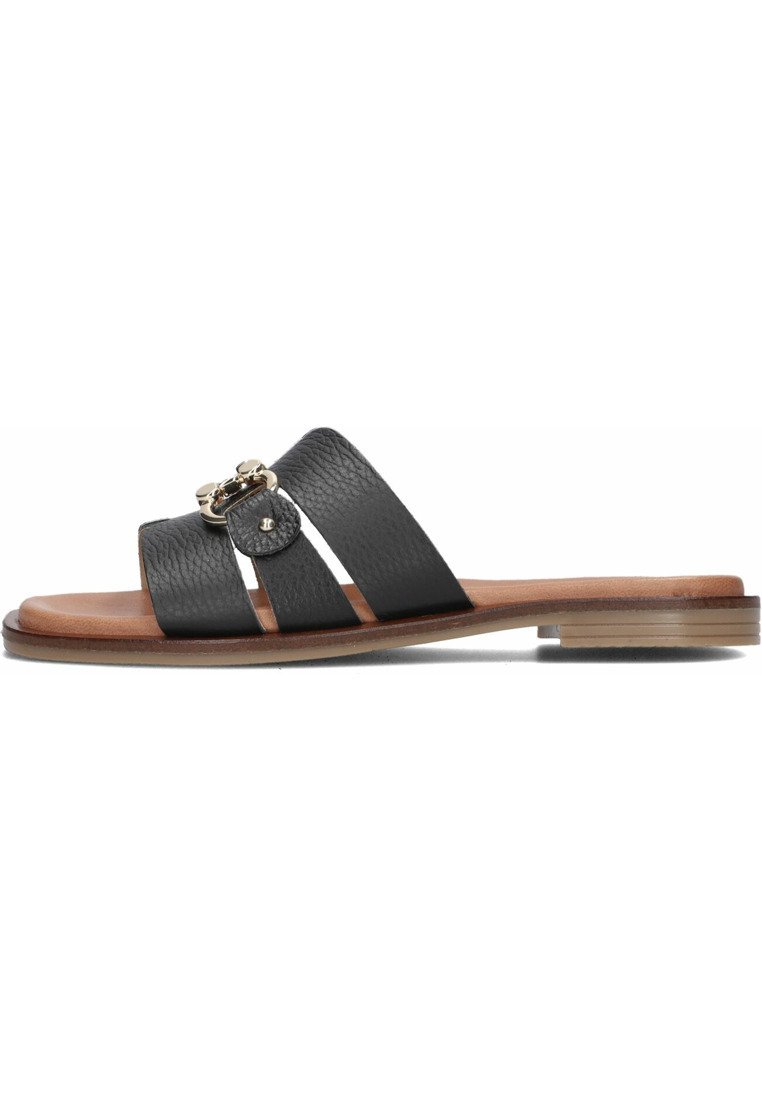 Zwarte leren slidersandalen met twee brede banden, textuurafwerking en decoratieve gouden hardwareaccenten aan de zijkant. Platte, natuurlijke houten zool.